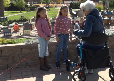 Older woman using A Better Walker talking with grandchildren